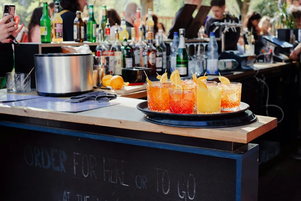 Tray of freshly prepared spritz drinks on an outdoor mobile bar